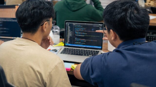 Developers pair-programming at a coding bootcamp in the Philippines